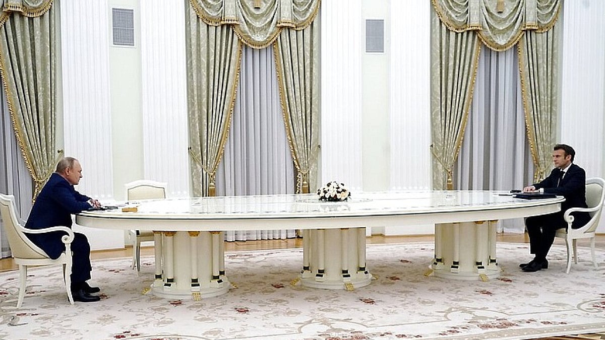 Russian President Vladimir Putin, left, listens to French President Emmanuel Macron.