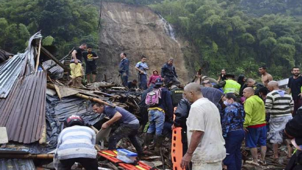 Rescue workers in the hunt for survivors after a rain-weakened hillside collapsed over homes in Pere
