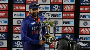 India captain Rohit Sharma poses with the winners trophy after beating West Indies in the third ODI.