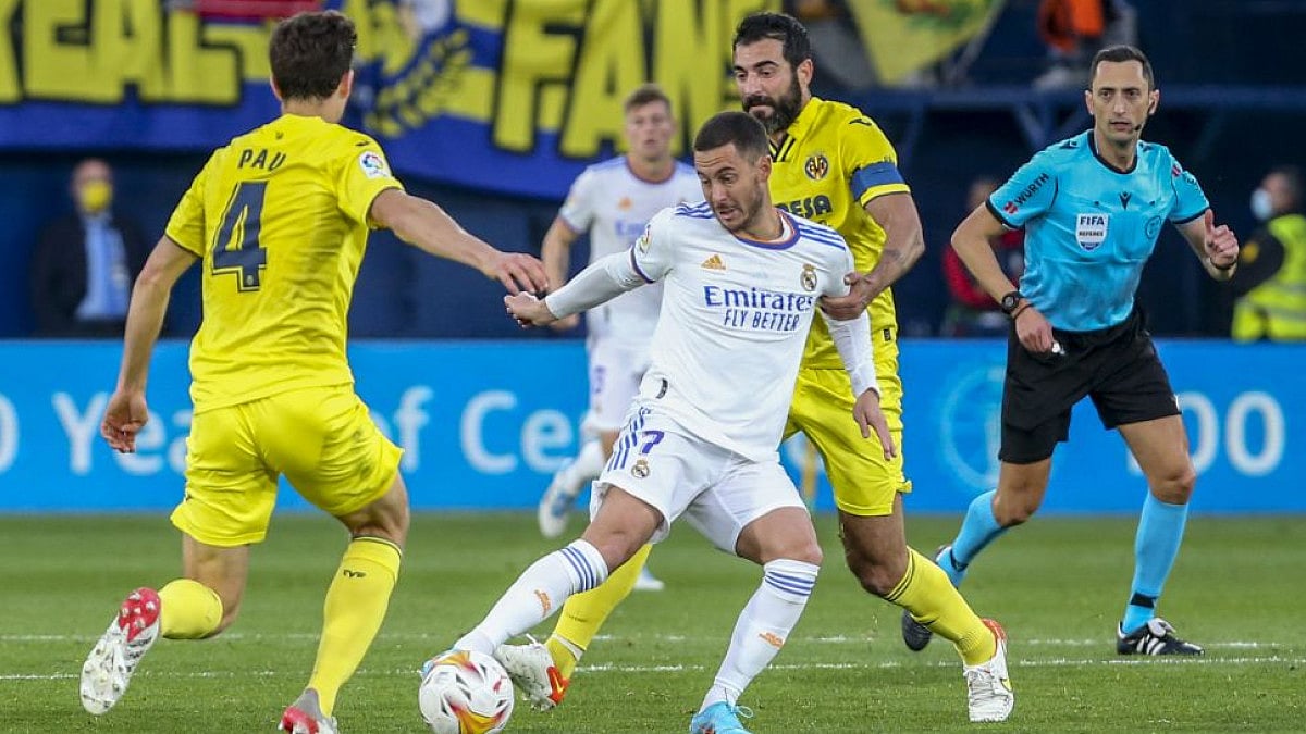 Real Madrid's Eden Hazard (center) vies for the ball with Villarreal players in La Liga 2021-22.
