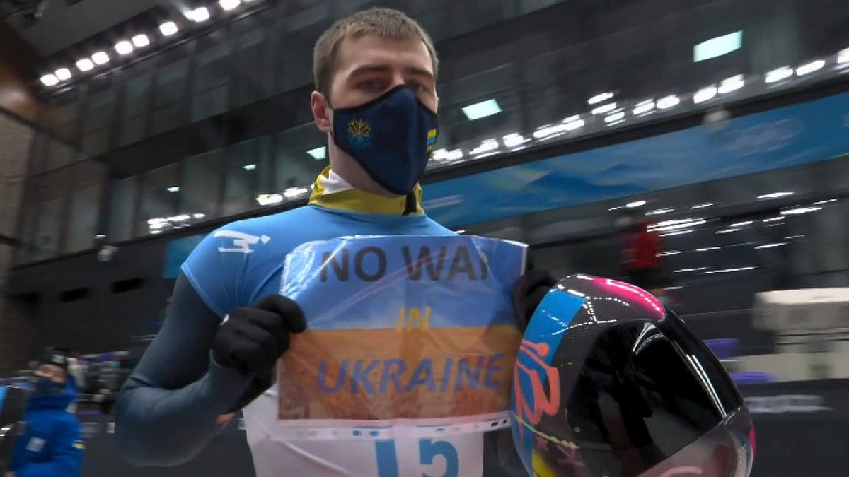 Vladyslav Heraskevych of Ukraine holds a sign that reads 'No War in Ukraine' in Beijing.