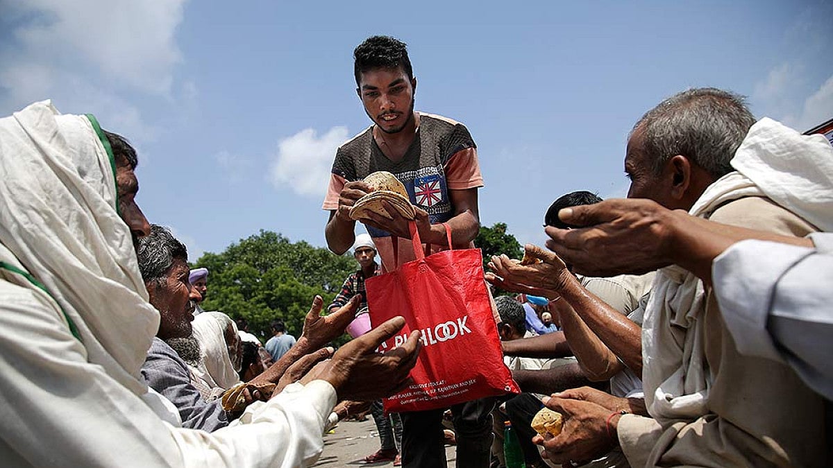 A Dera member serves roti to the needy in Punjab 