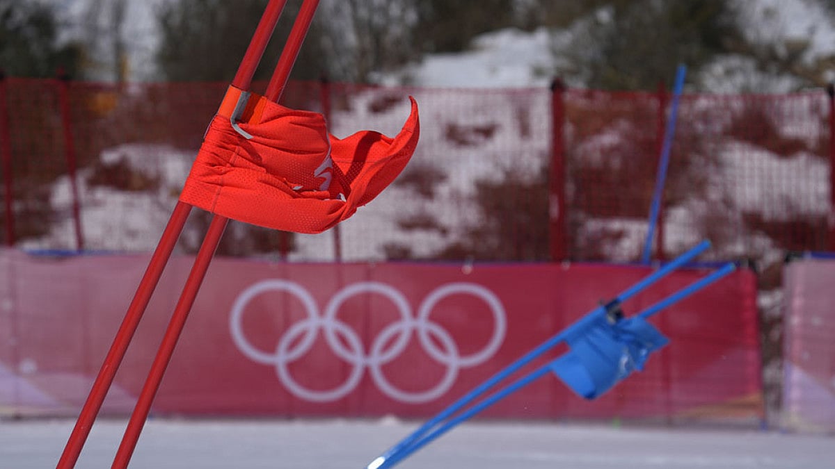 Gate flags bend in the wind at the 2022 Winter Olympics.
