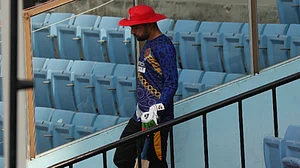Afghanistan spinner Rashid Khan walks down the stairs to enter the ground for training on Tuesday.