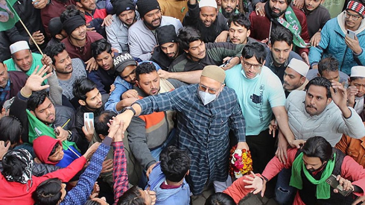 AIMIM President Asaduddin Owaisi greets his supporters during a campaign in Meerut, UP.