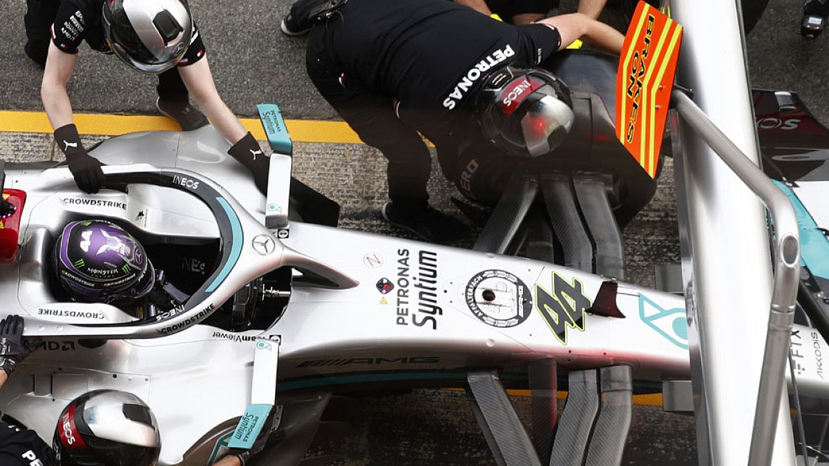 Mechanics work on the car of Mercedes driver Lewis Hamilton during a Formula One pre-season testing.