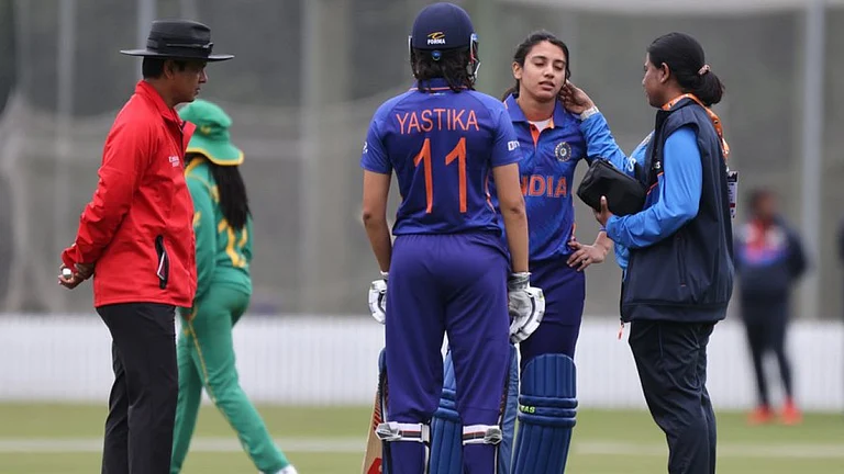 India's Smriti Mandhana is treated after being hit on head against South Africa on Sunday. - null