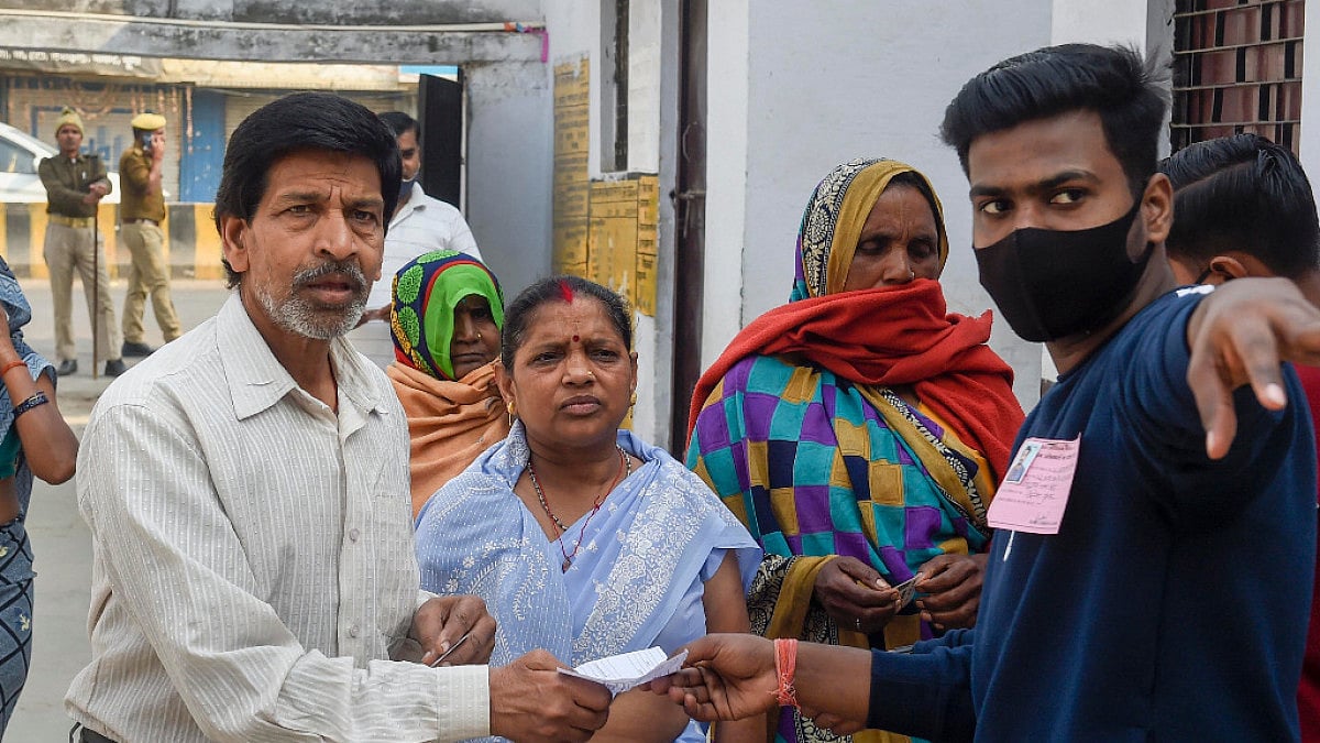 People wait to cast their vote during the fifth phase of UP Assembly polls, in Prayagraj.