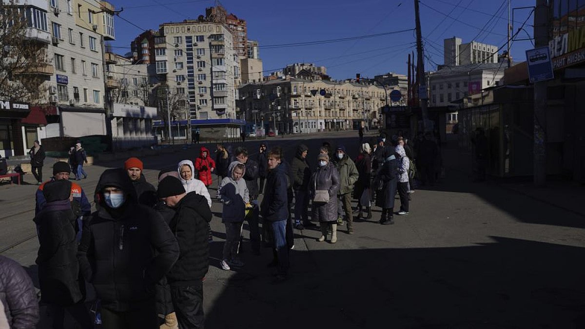 People wait in a queue outside a supermarket in central Kyiv, Ukraine.