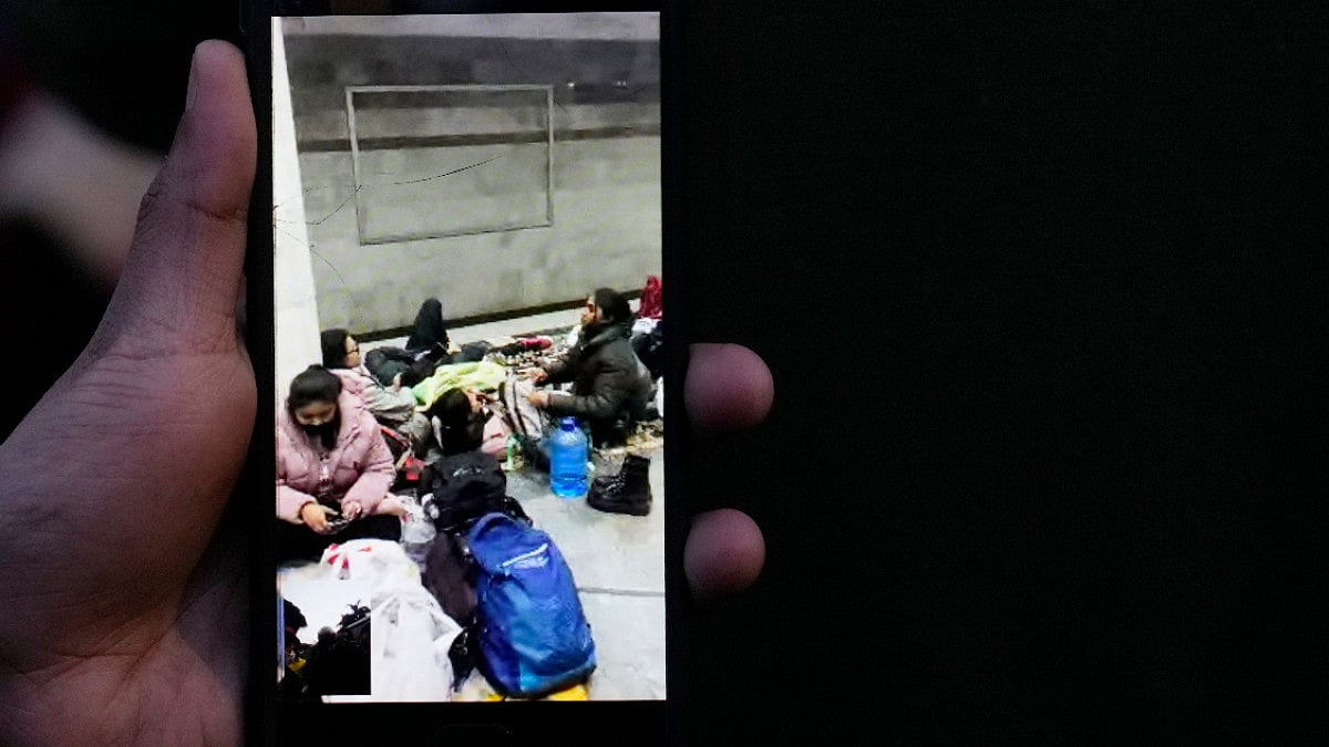 A person shows a video on his mobile phone, sent by his relative studying in Kharkiv University in n