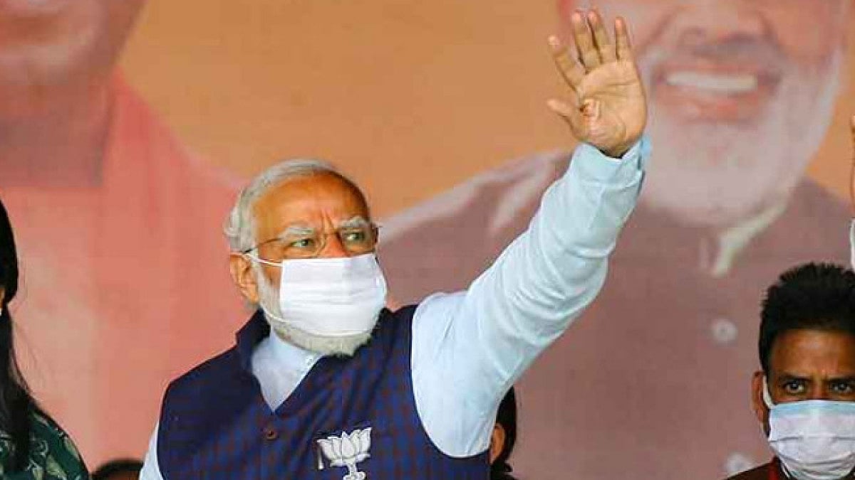 Prime Minister Narendra Modi wave towards supporters in ongoing UP elections.