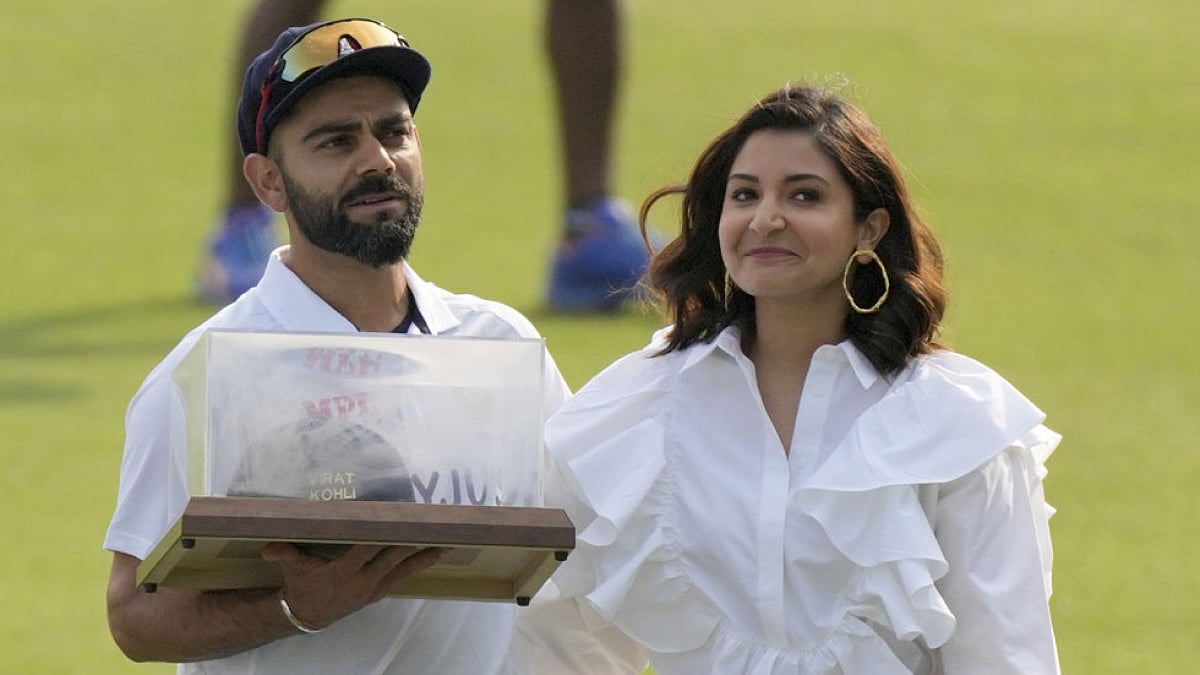 India's Virat Kohli and his wife Anushka Sharma pose during a facilitation ceremony in Mohali.