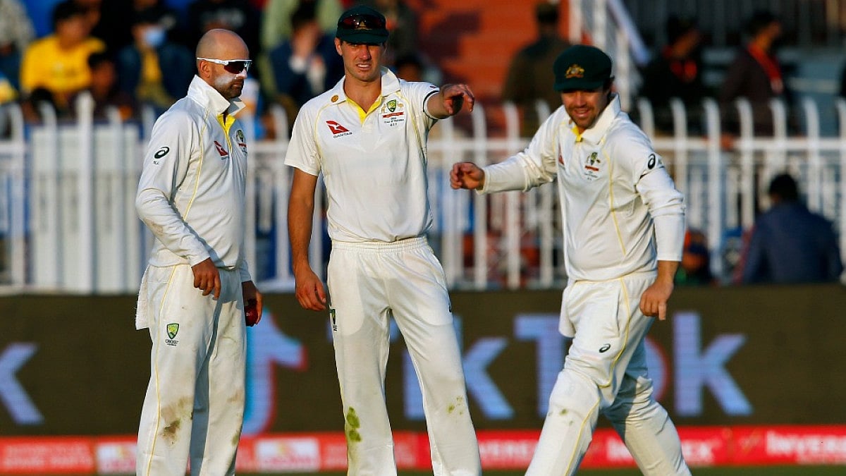 Australian skipper Pat Cummins (C) chats with teammates in the first Test vs Pakistan in Rawalpindi.
