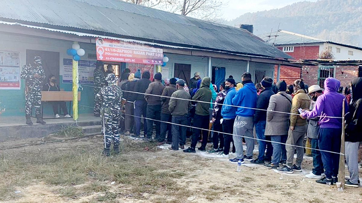 Voters wait in a queue to cast their votes at polling booth, during 2nd phase of Manipur election