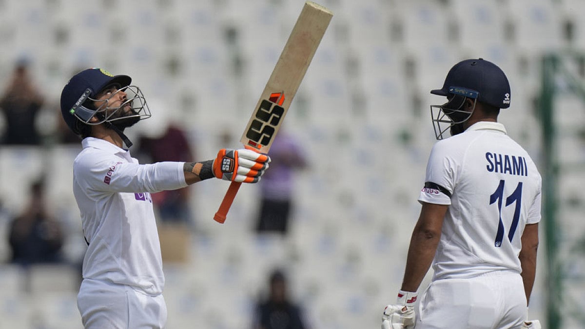 India's Ravindra Jadeja, left, raises his bat after scoring 150 against Sri Lanka in Mohali.