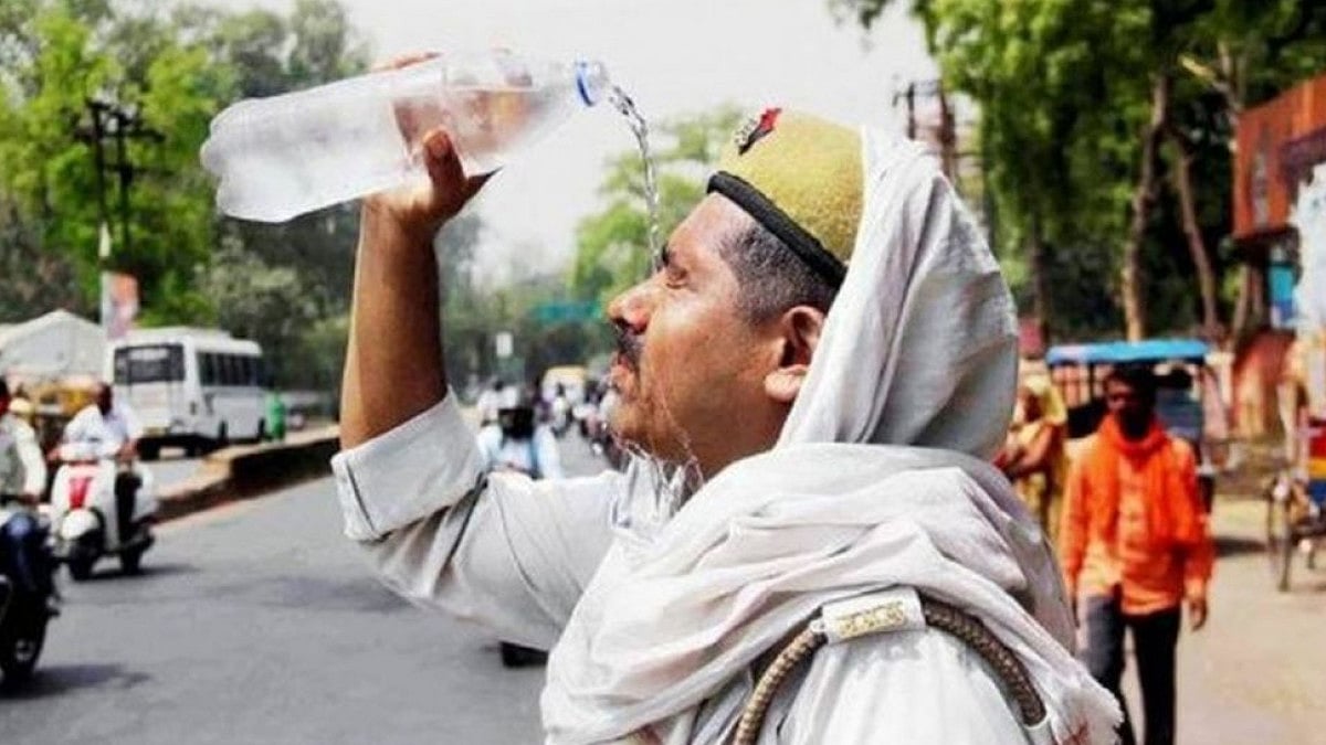 A police officer pours water in over his head, as temperature in the national capital soars to 27 de