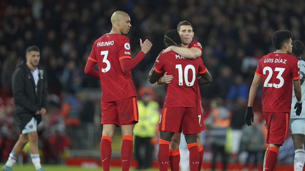 Liverpool's Sadio Mane hugs teammate to celebrate win over West Ham United In Premier League.