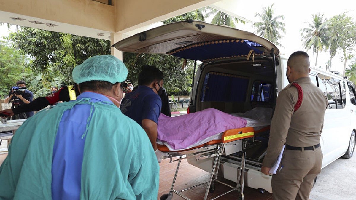 Staff members help move the body of Shane Warne from Ko Samui Hospital on March 6, 2022.