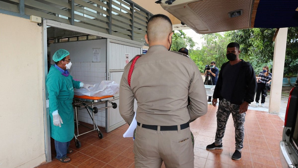 Staff members help move the body of Shane Warne from Ko Samui Hospital on Ko Samui island on Sunday.