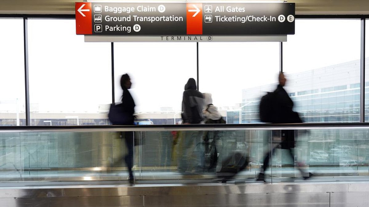 Travelers walk to their gates at an international airport 