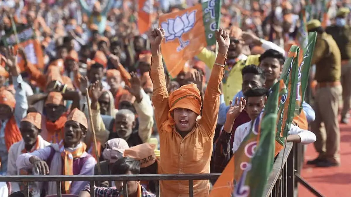 A BJP supporter cheers for the party during a campaign rally in Gorakhpur