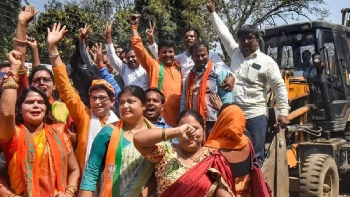 BJP supporters celebrate Yogi Adityanath's victory in Uttar Pradesh atop a bulldozer. 