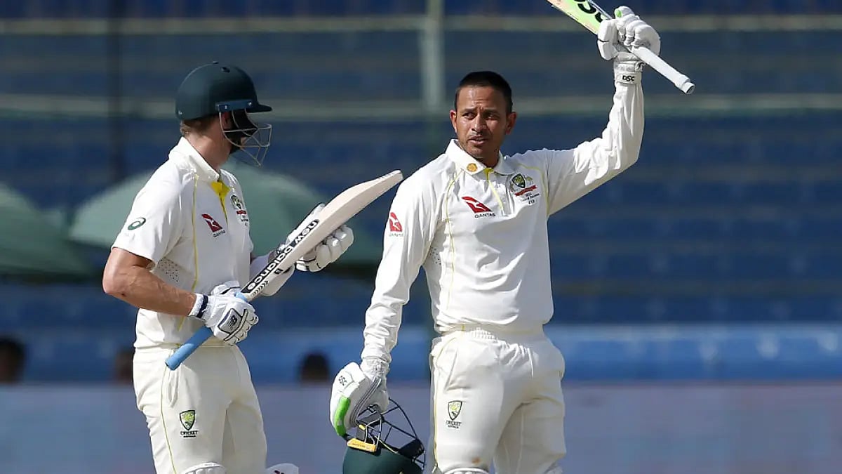 Australia's Usman Khawaja, right, celebrates his century on Day 1 of the 2nd Test against Pakistan.