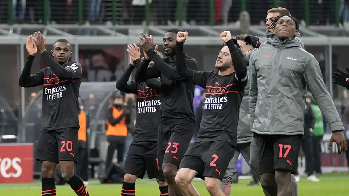 AC Milan players applaud the fans at the end of their Serie A match against Empoli.