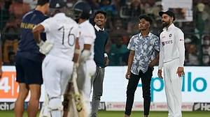 Virat Kohli (R) poses for a selfie with fans who intruded the pitch area in 2nd Test vs Sri Lanka.
