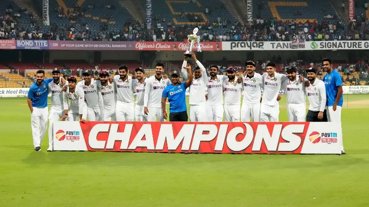 Indian players celebrate with the winners' trophy after beating Sri Lanka in the 2nd Test.