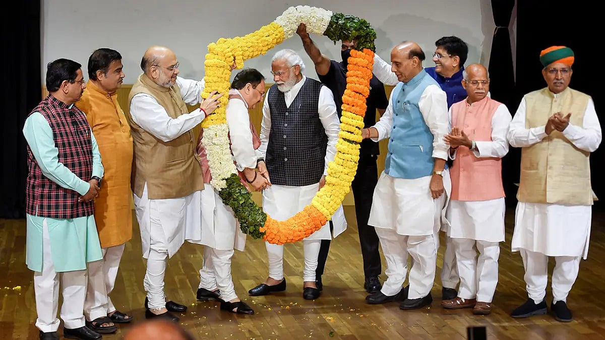 Prime Minister Narendra Modi being garlanded during the BJP parliamentary party meeting after BJP's 