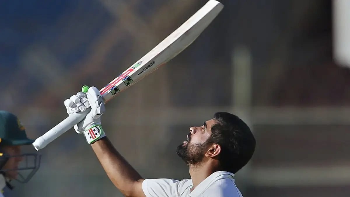 Pakistan's Babar Azam celebrates after completing his century in Karachi Test against Australia.