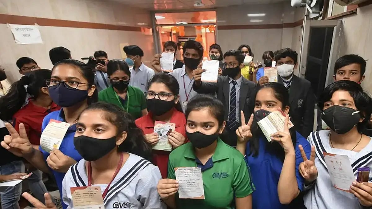 Students in the age group of 12-14 years, show their vaccination certificates