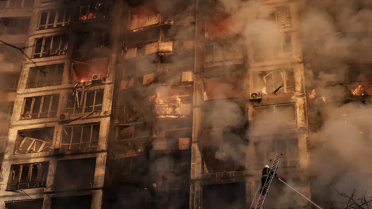 Firefighters extinguish flames in an apartment building after being hit by shelling in Kyiv.