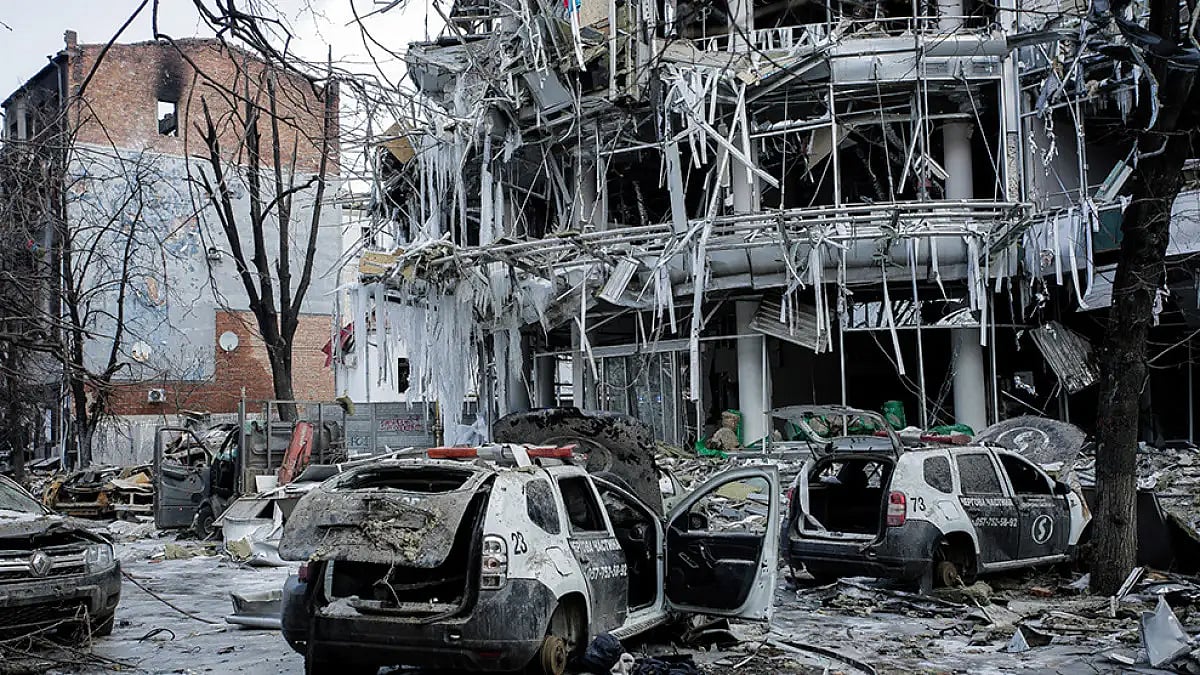 Damaged vehicles sit among debris and in Kharkiv city centre in Ukraine.
