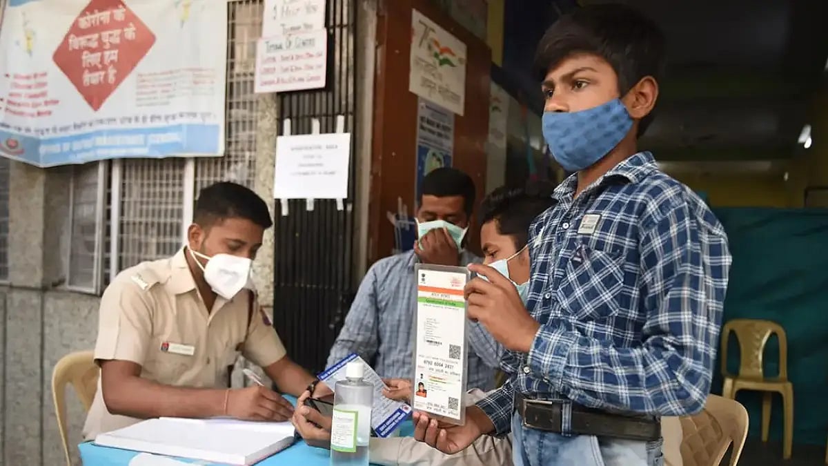 A student of the age group of 12-14 years, shows his identification card as he receive a dose 