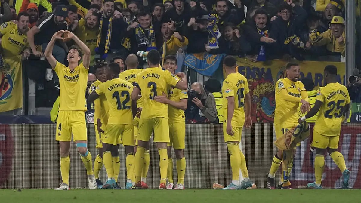 Villarreal players celebrate a goal against Juventus during their Champions League match.