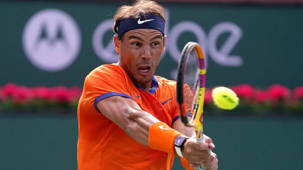 Rafael Nadal returns a shot to Carlos Alcaraz in men's singles semis at Indian Wells Masters 2022.