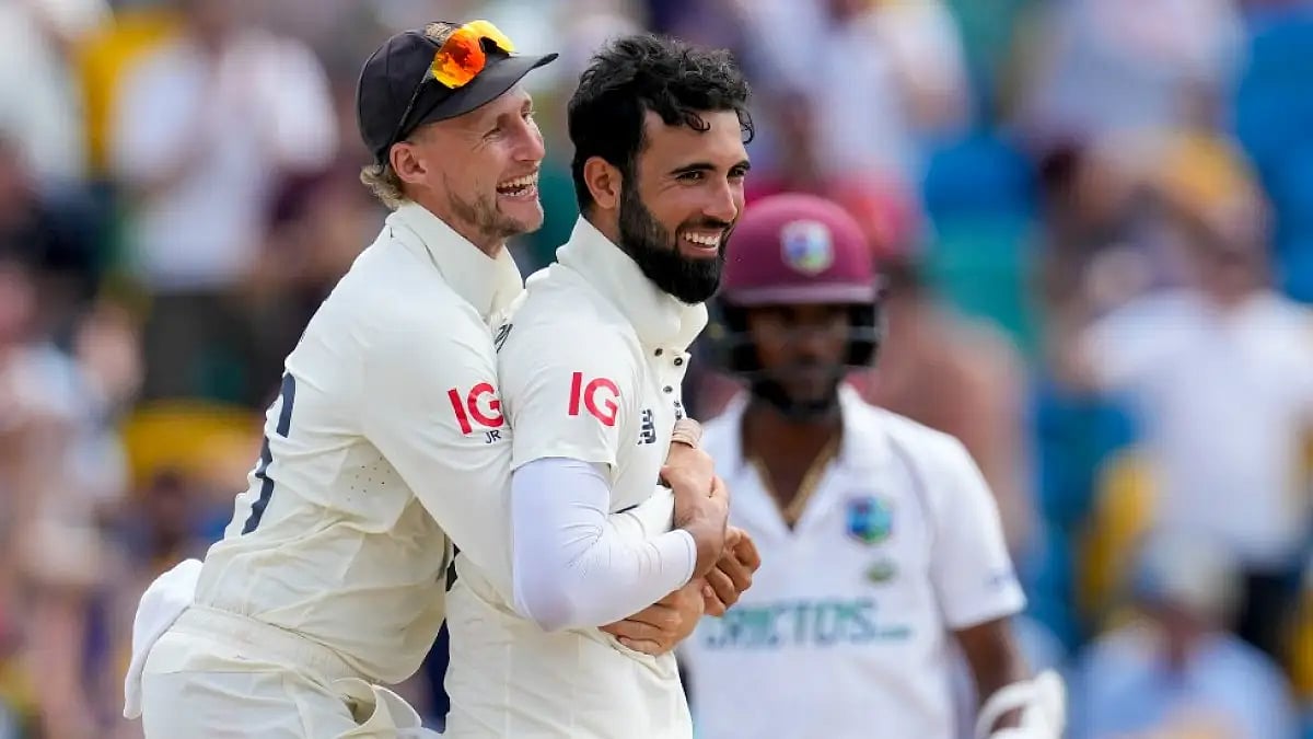 England's Joe Root embraces Saqib Mahmood after he dismissed West Indies' Jason Holder in 2nd Test.