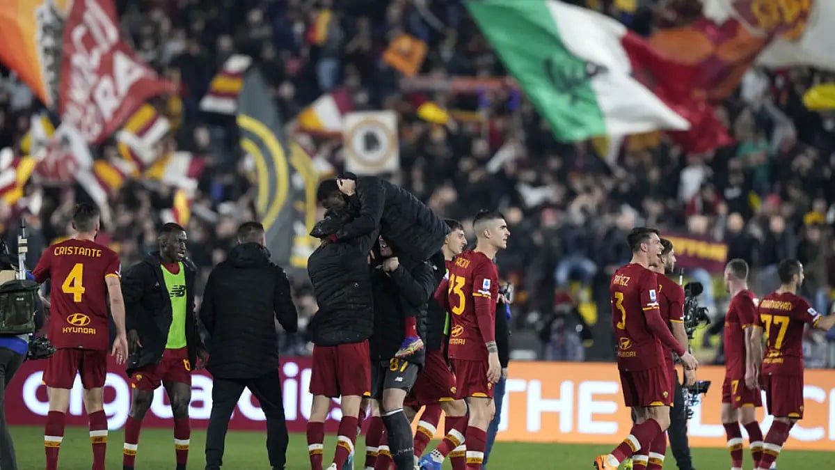AS Roma's players celebrate at the end of their Serie A match against Lazio.