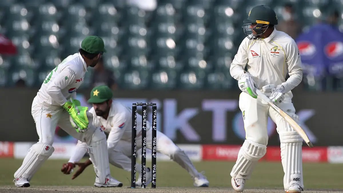 Australias Usman Khawaja watches as Pakistans Babar Azam takes the catch to dismiss him in Lahore.