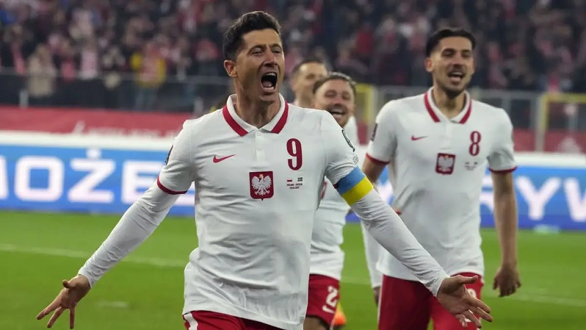 Poland's Robert Lewandowski celebrates after scoring a goal during World Cup 2022 playoff vs Sweden.