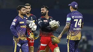 Dinesh Karthik, centre, after helping RCB beat KKR in IPL 2022. Catch highlights and scores.