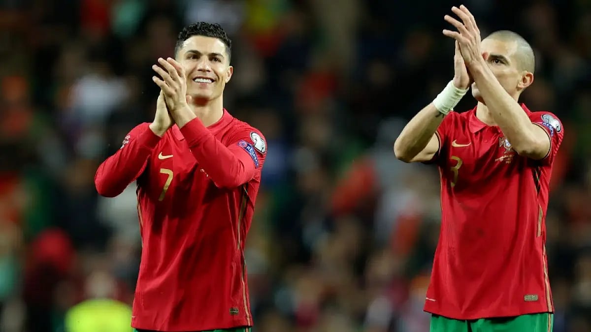 Portugal's Cristiano Ronaldo (L) and Pepe celebrate after beating North Macedonia in WC playoffs.