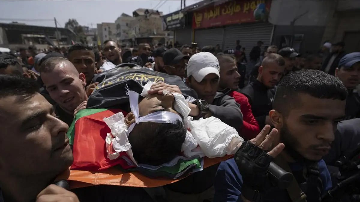 Palestinian mourners carry the body of Sanad Abu Atiyeh, 17 during his funeral in the West Bank.