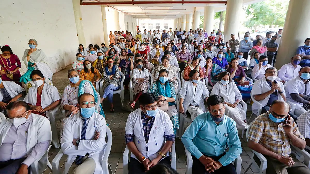 Doctors seated at a gathering. 