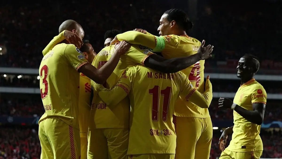 Liverpool players celebrate a goal against Benfica during their UEFA Champions League match.