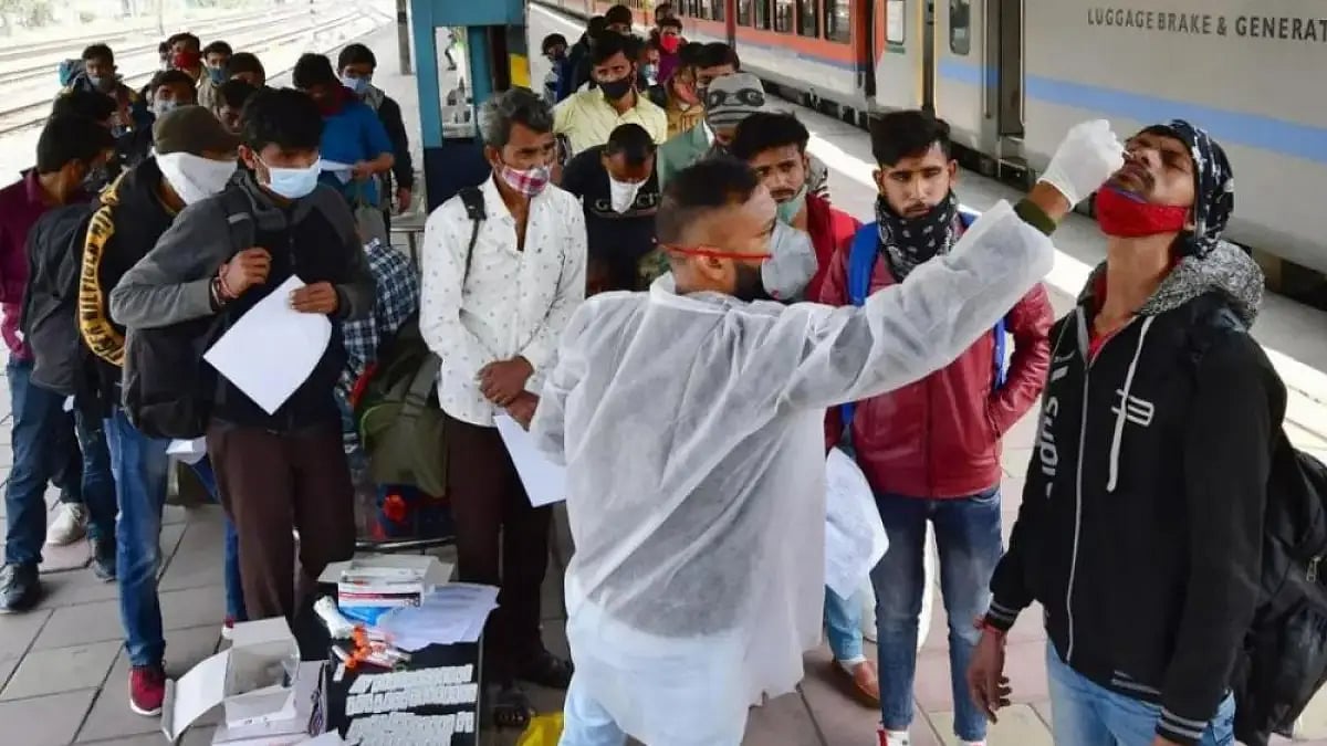 A health worker collects swab samples of a passenger for Covid-19 test in Mumbai. 