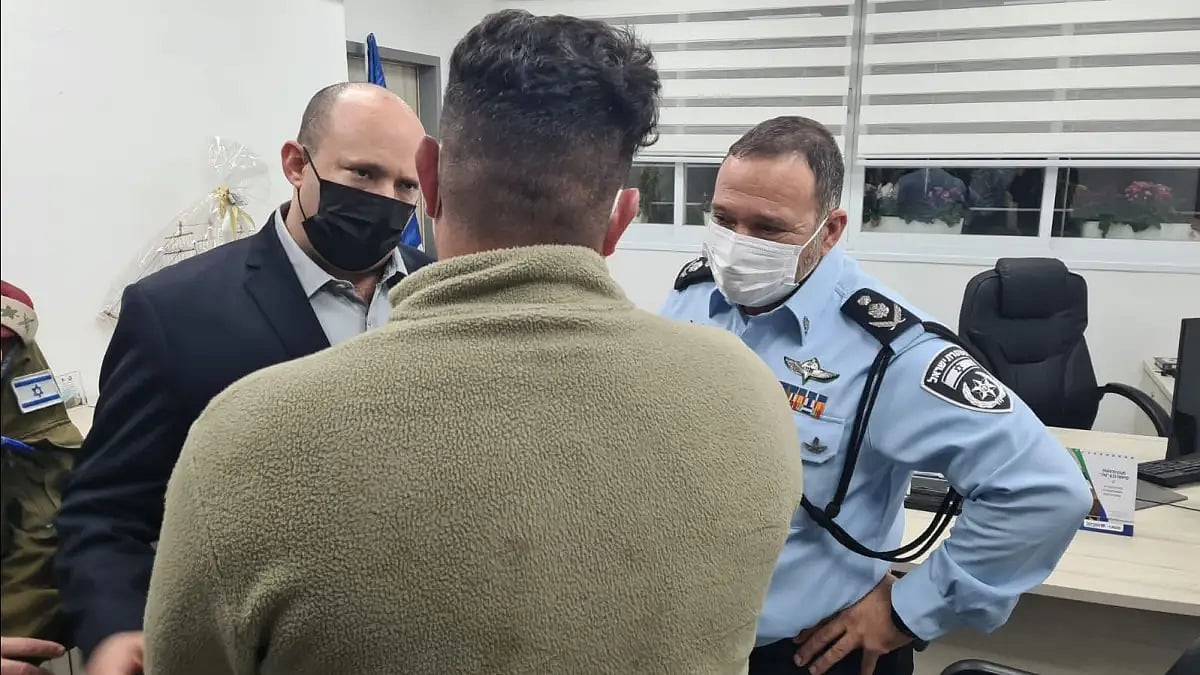 Israel's PM Bennet talking to security forces personnel after a recent attack