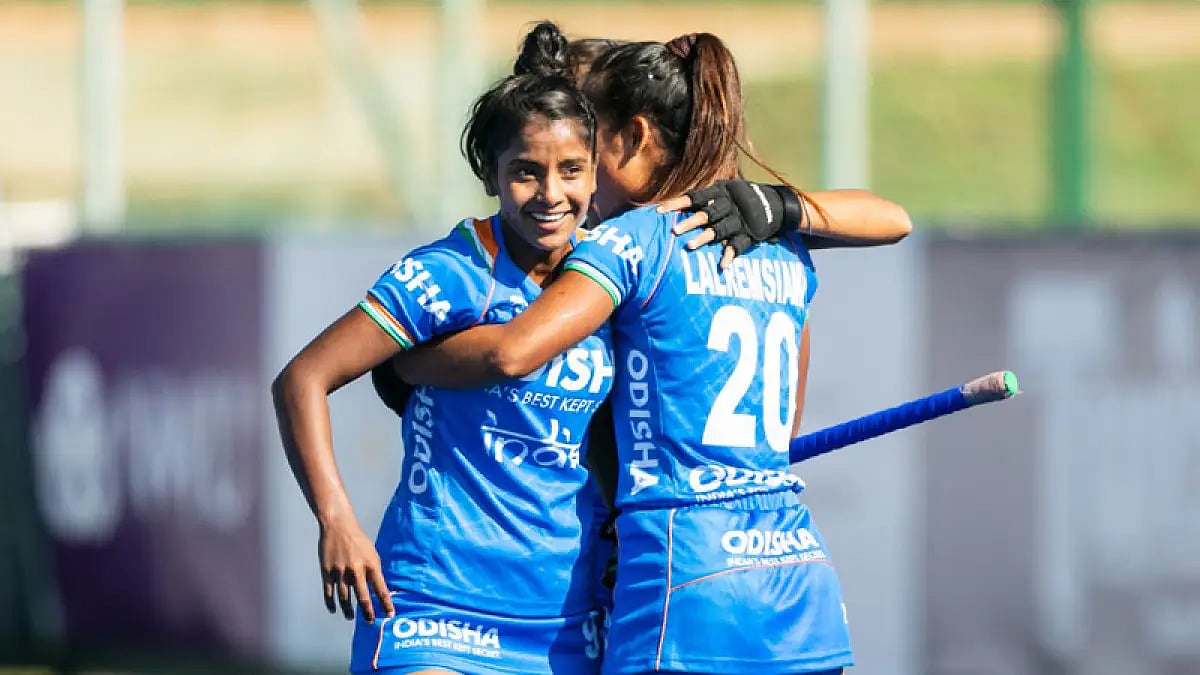 India's Mumtaz Khan, left, celebrates a goal against South Korea.